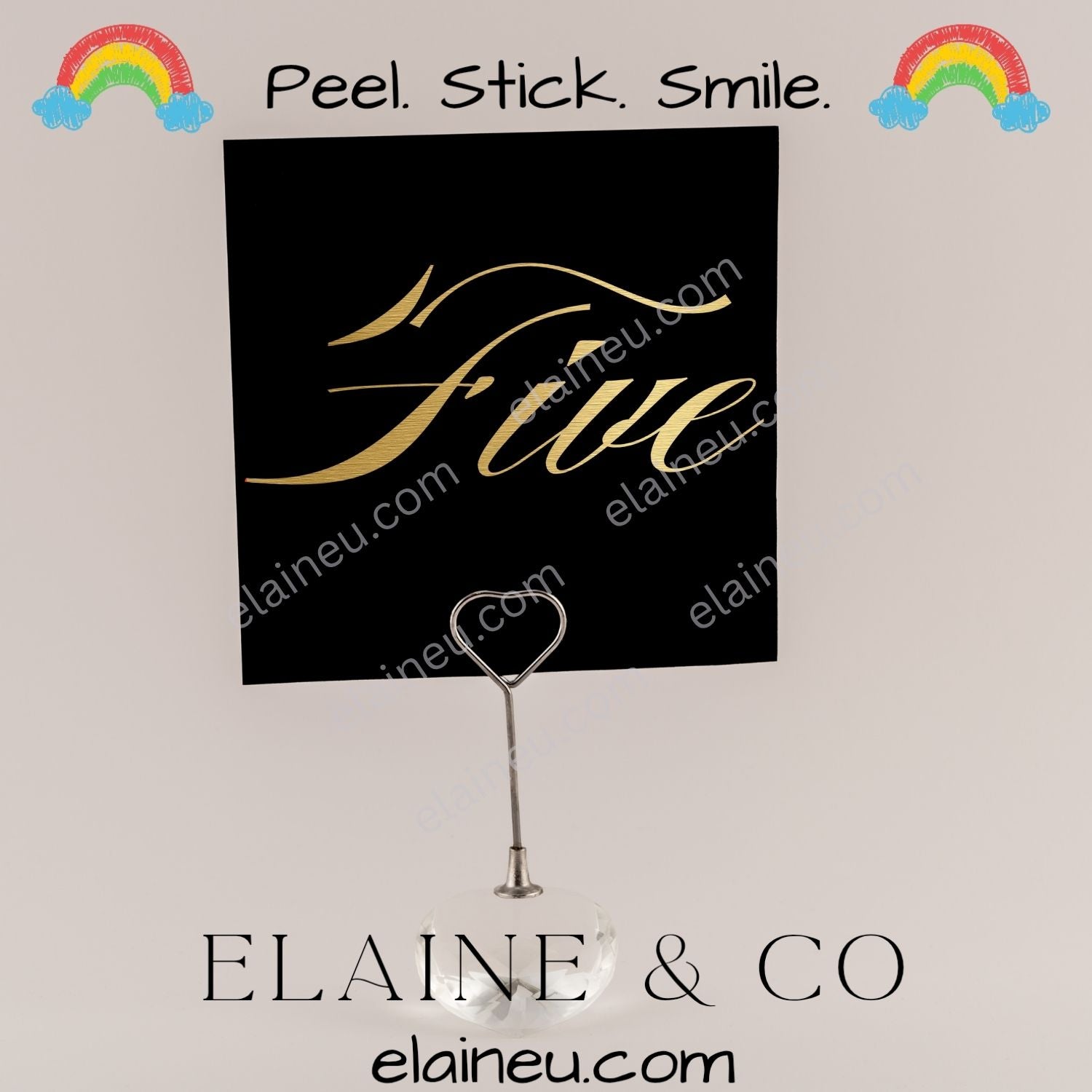 Decorative wall decal with 'Stile' text and heart-shaped hook on a light gray background, featuring 'Elaine & Co' branding.