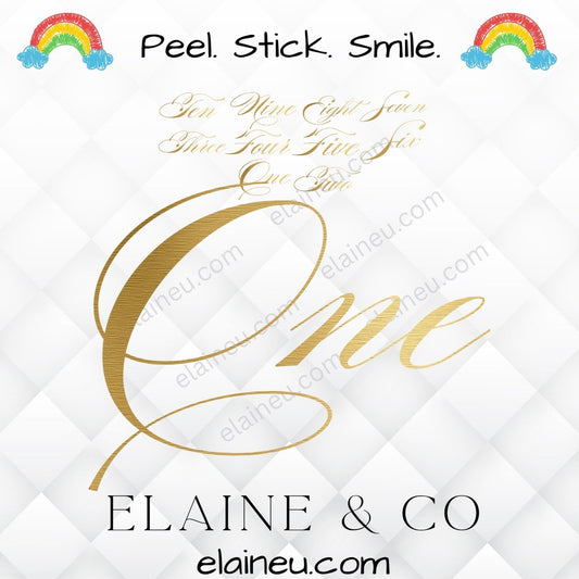 Gold 'One' design with rainbow and cloud decorations on a white background, featuring the brand 'Elaine & Co'.